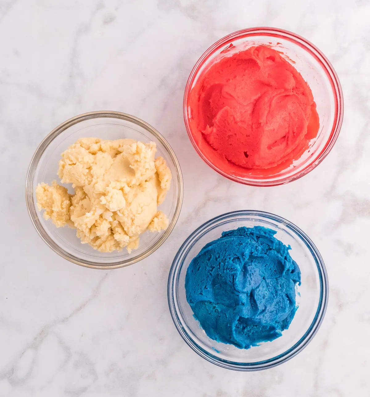 Cookie dough in three containers that is red, white, and blue
