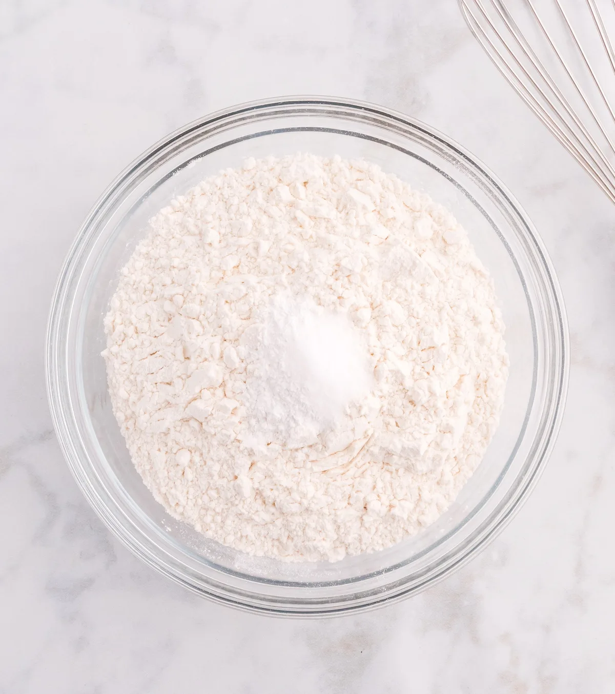 Flour, baking soda, and salt whisked together in a bowl