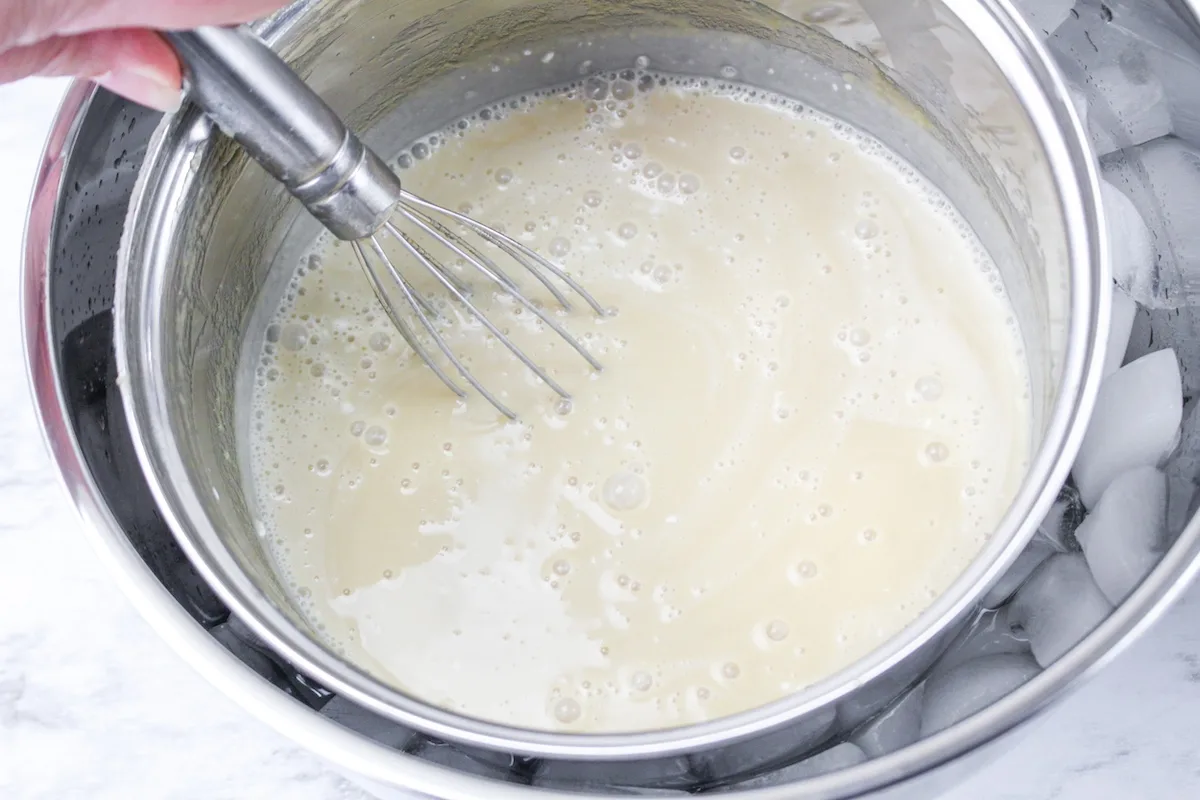 Stirring the heavy whipping cream into the icee cream mixture