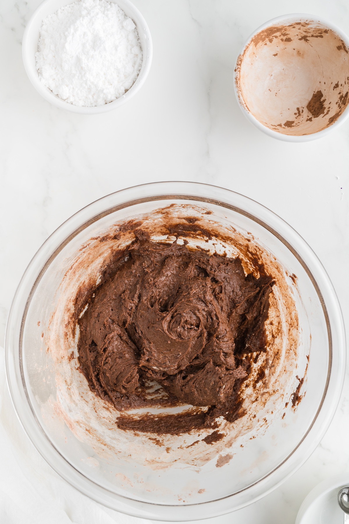 mixed chocolate crinkle dough ina clear glass mixing bowl
