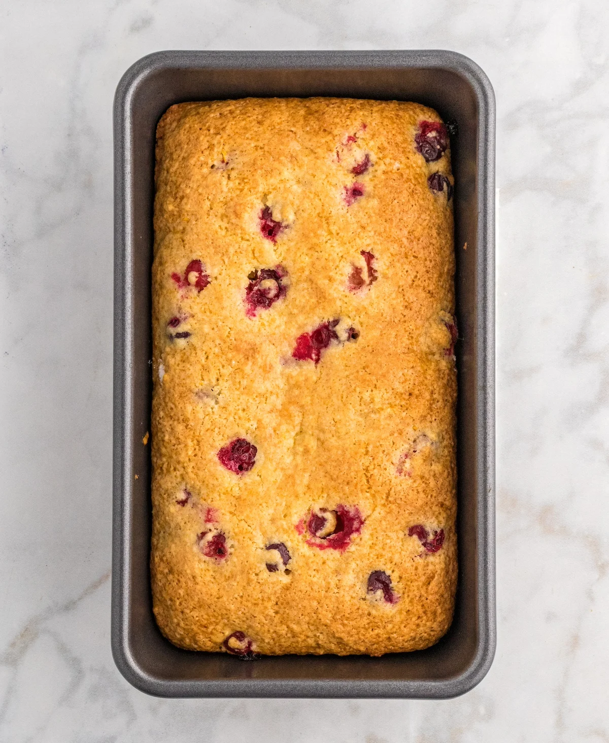 Baked cranberry orange bread in a loaf pan