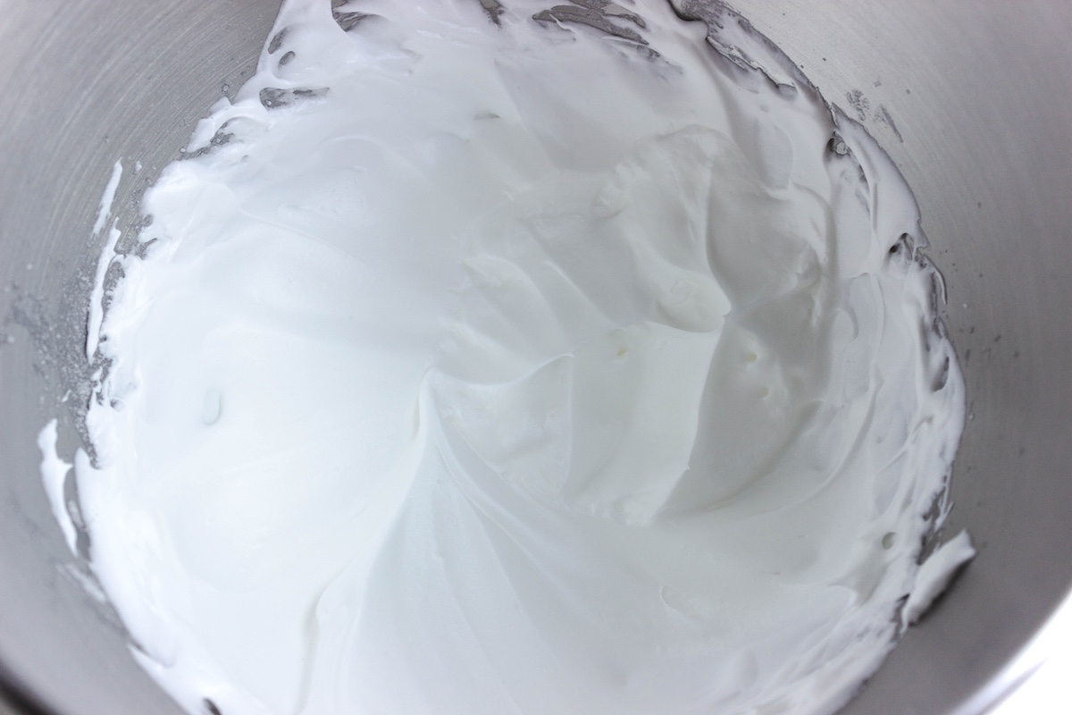 Beating egg whites with sugar in a metal bowl