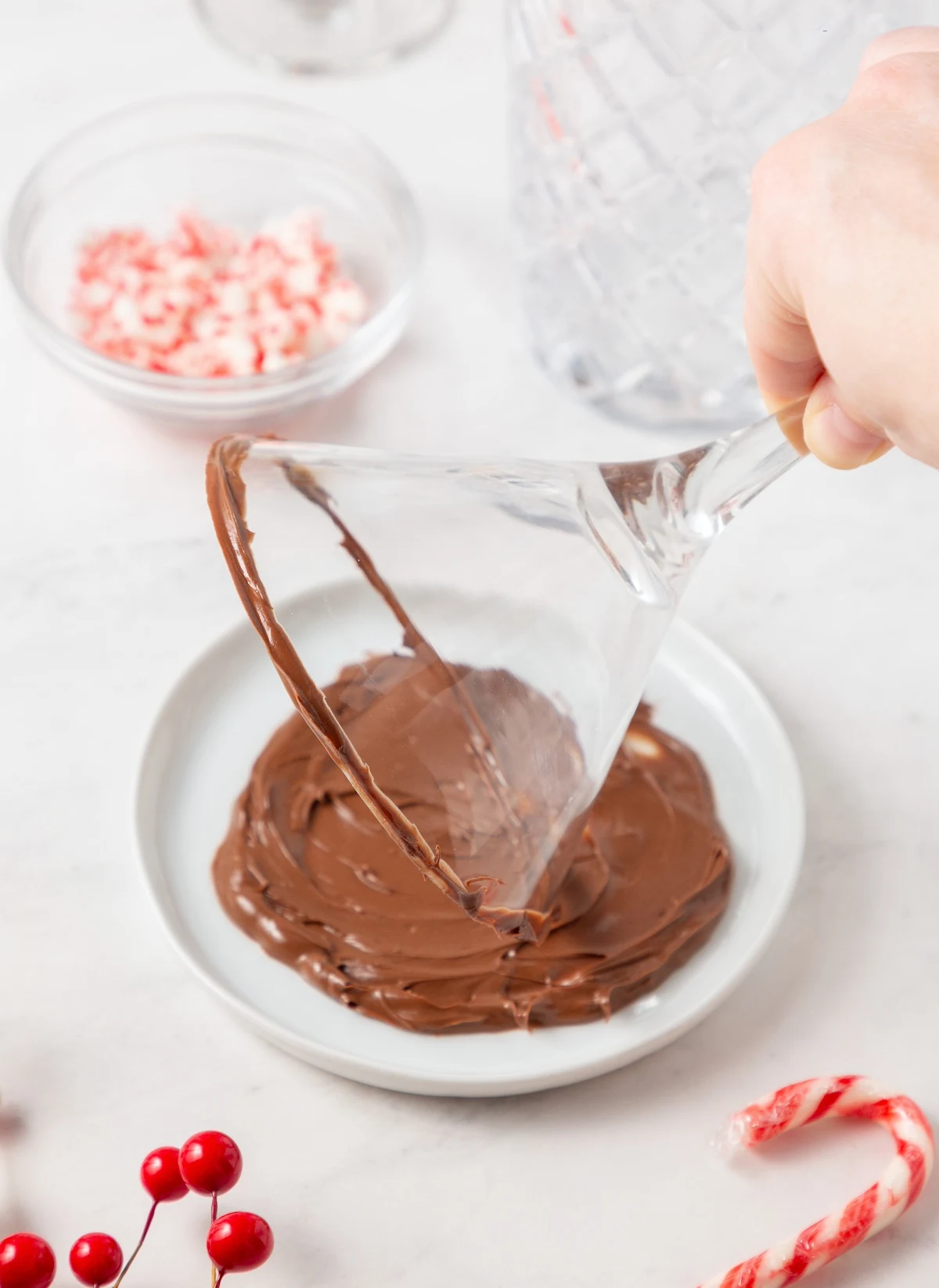 Dipping the martini glass into the melted chocolate