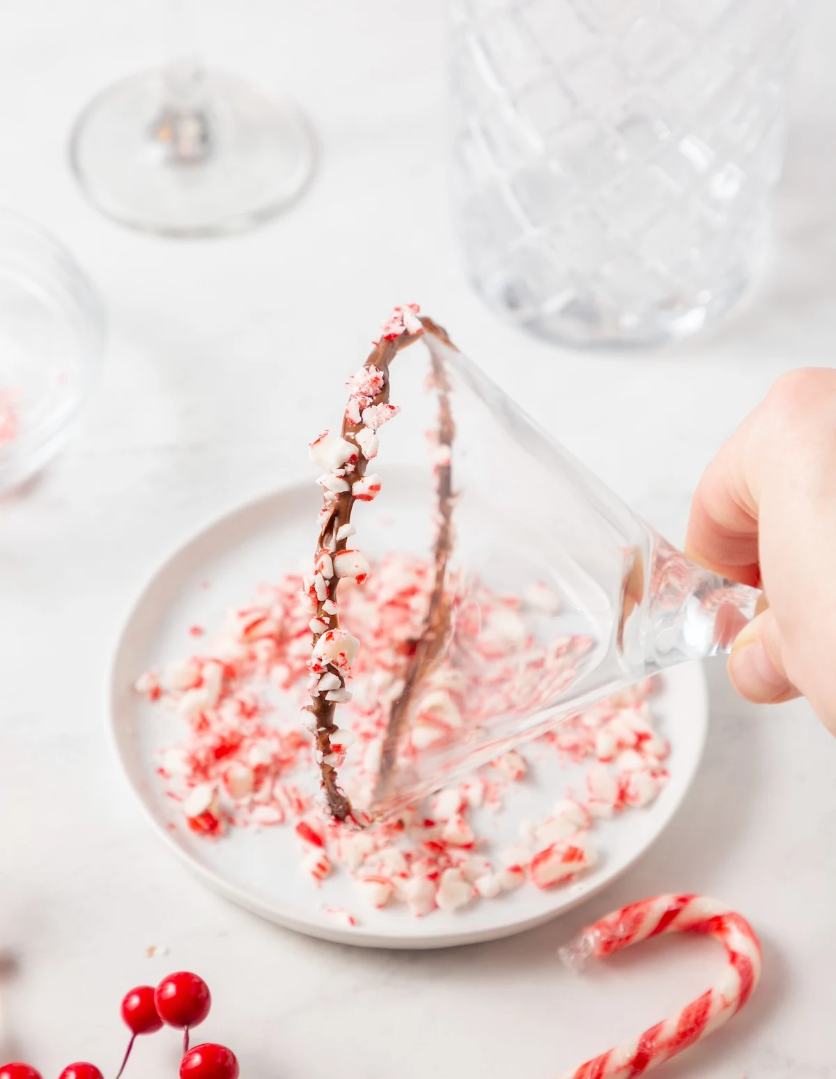 Dipping the melted chocolate into the candy cane pieces