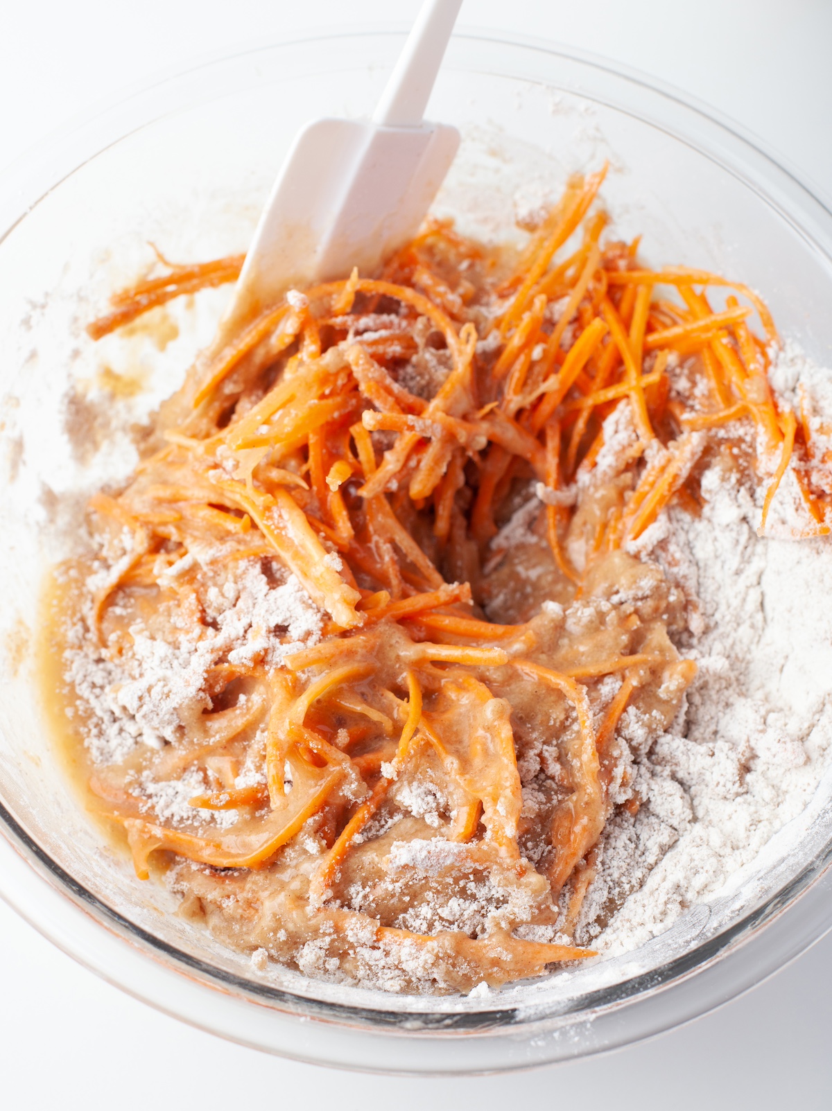 Folding the wet carrot mixture into the dry ingredients