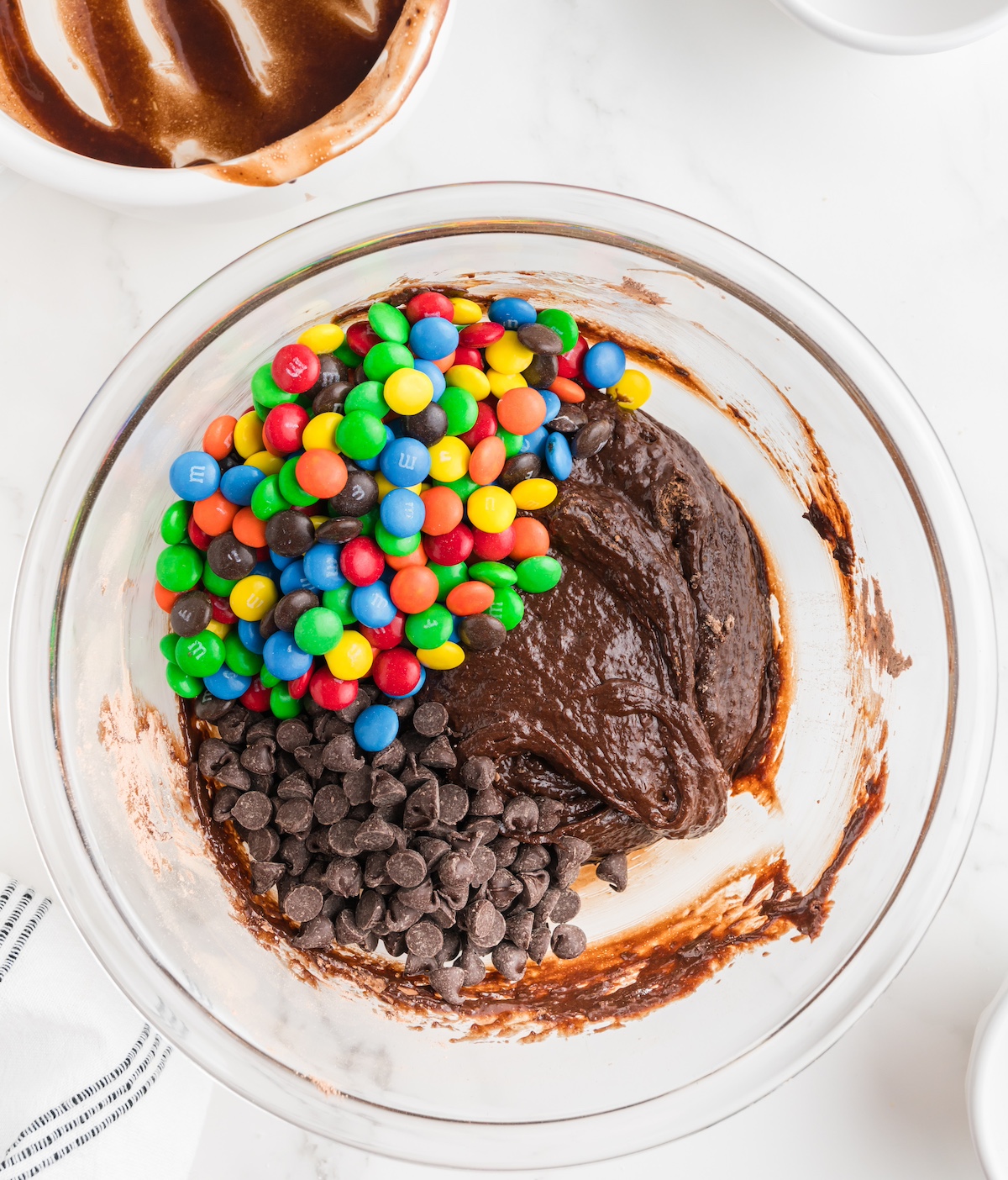 M&Ms and chocolate chips folded into the batter