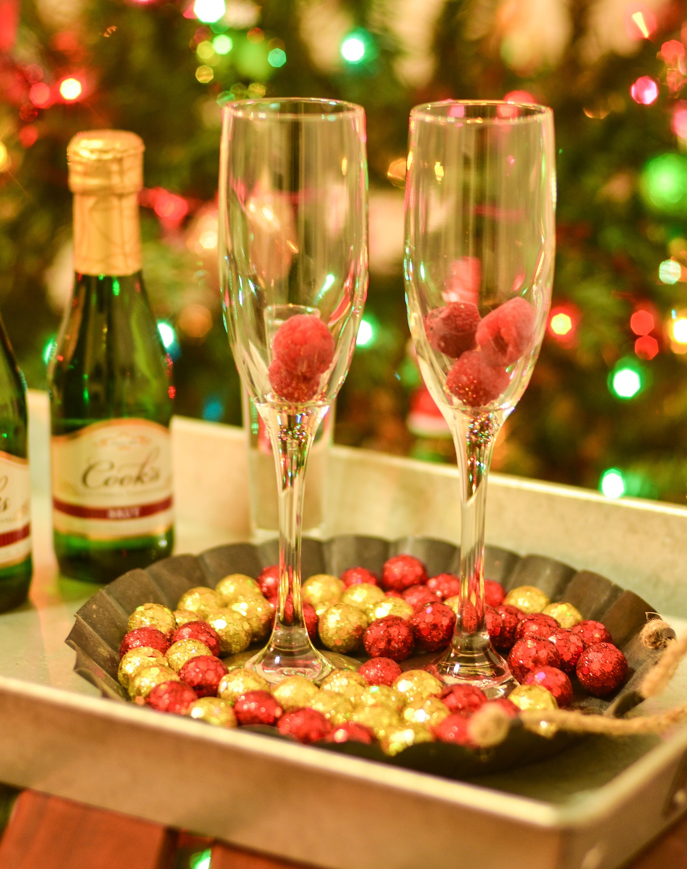 Raspberries added to champagne glasses