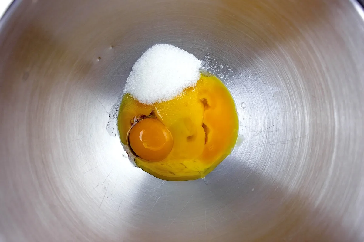 Sugar and egg yolks together in a metal bowl