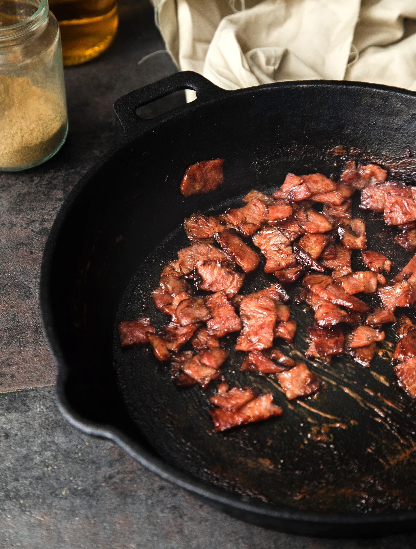 glazed bacon in a cast iron pan