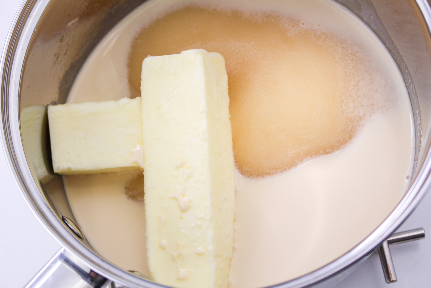 Butter, granulated sugar, and evaporated milk in a saucepan