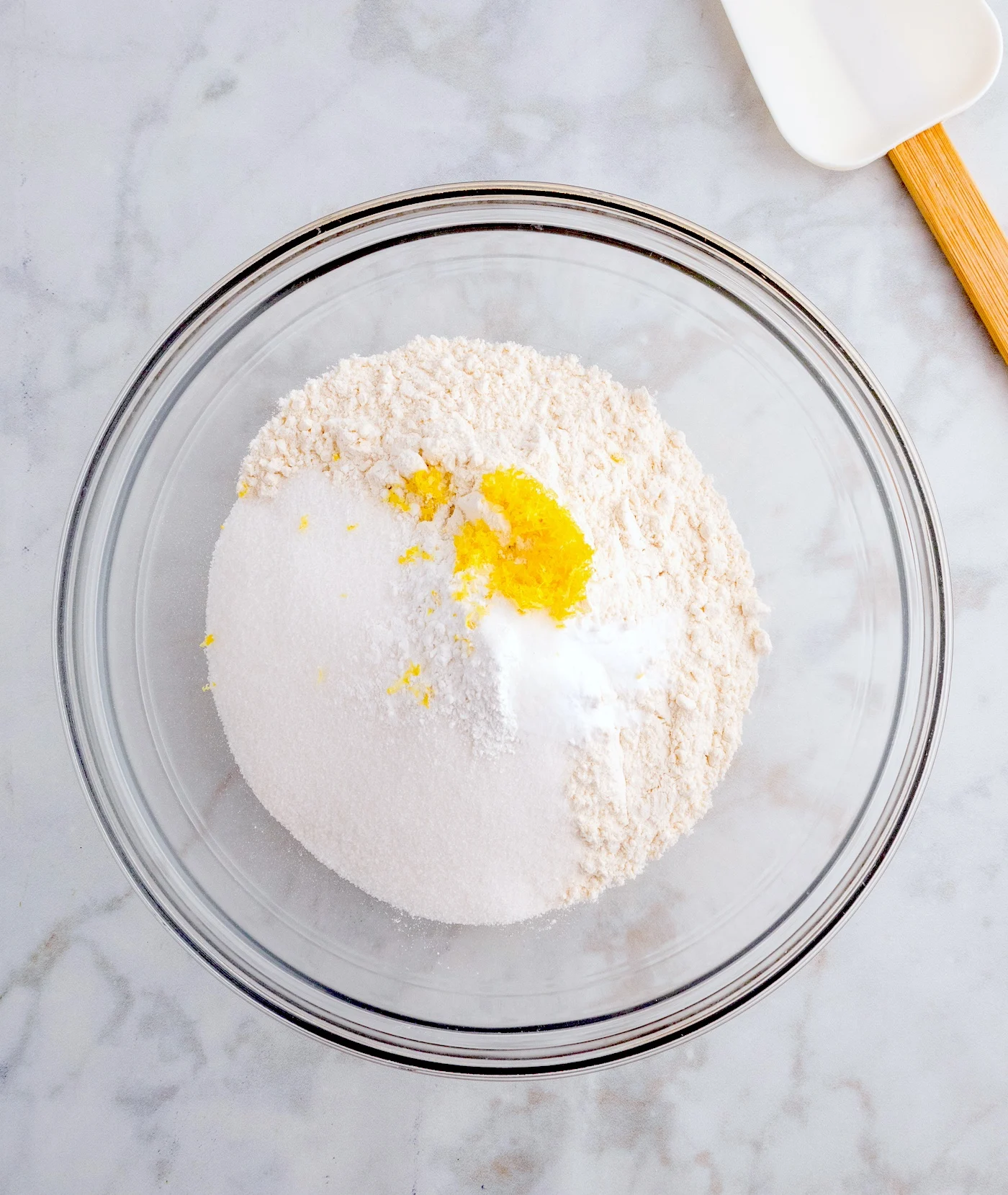 Combine the flour, granulated sugar, baking powder, baking soda, salt, and lemon zest in a bowl