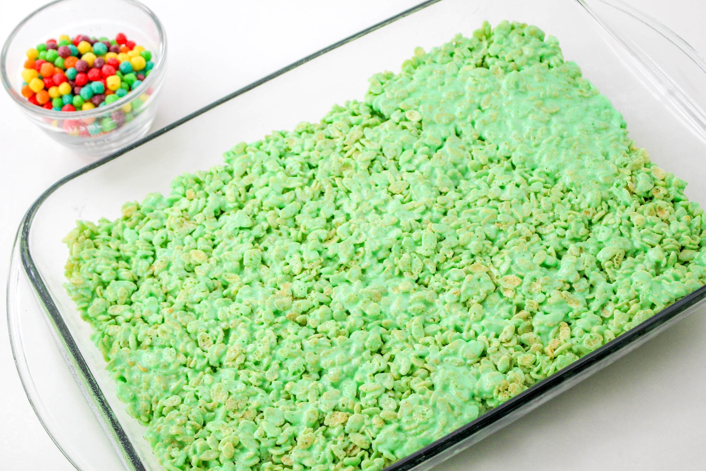 Green rice krispie treats pressed into a pan