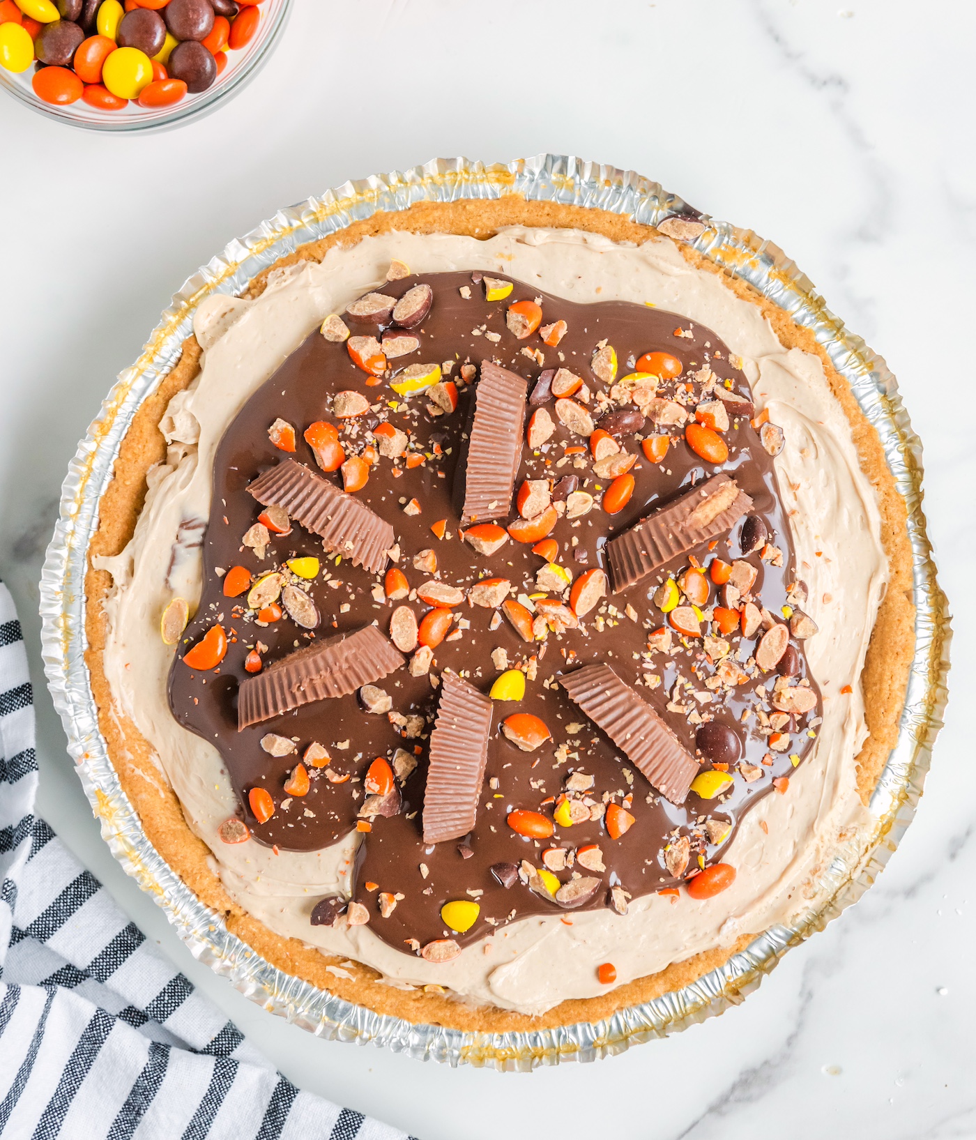 Mini reese's pieces sprinkled onto the top of the pie