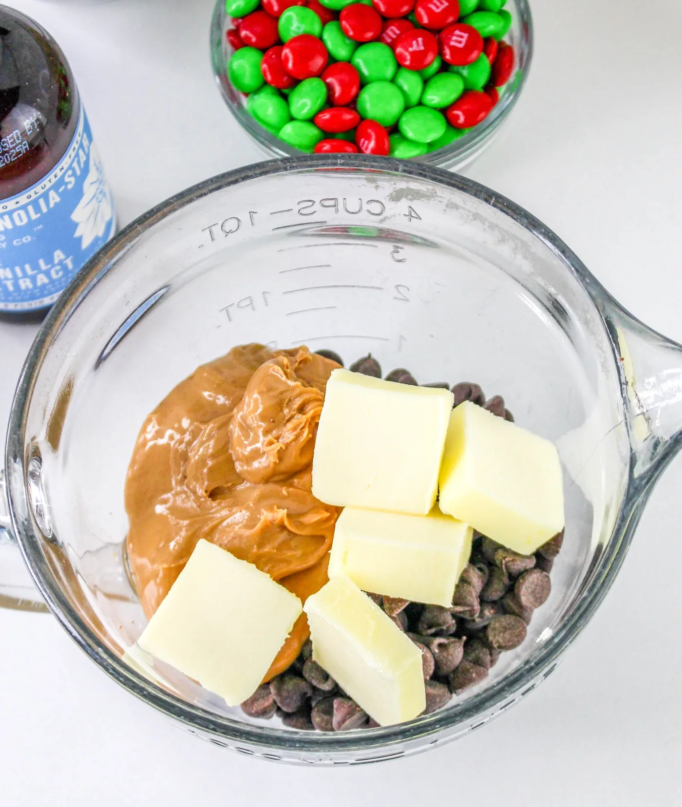 Peanut butter, butter, and chocolate chips in a large glass measuring cup