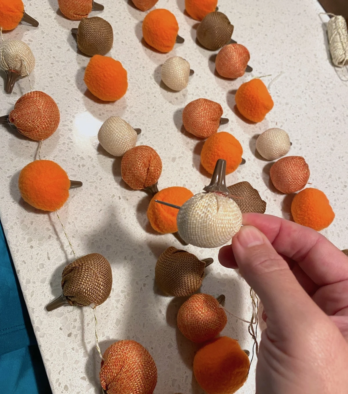 Stringing pumpkins onto a needle