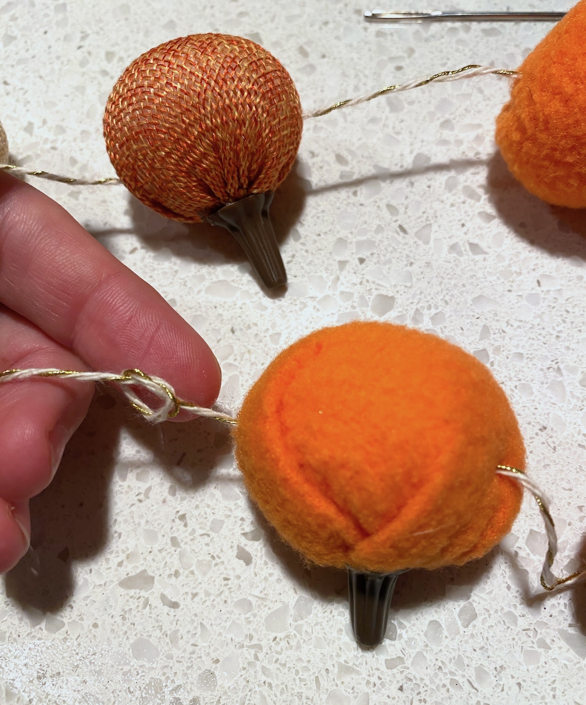 Tying a knot after each pumpkin is placed