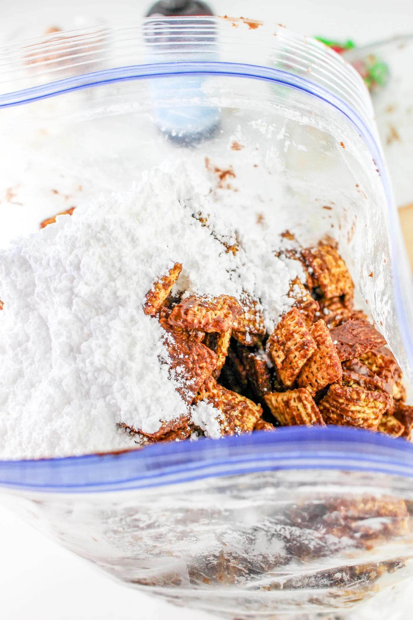 chex cereal shaken with powdered sugar in a bag