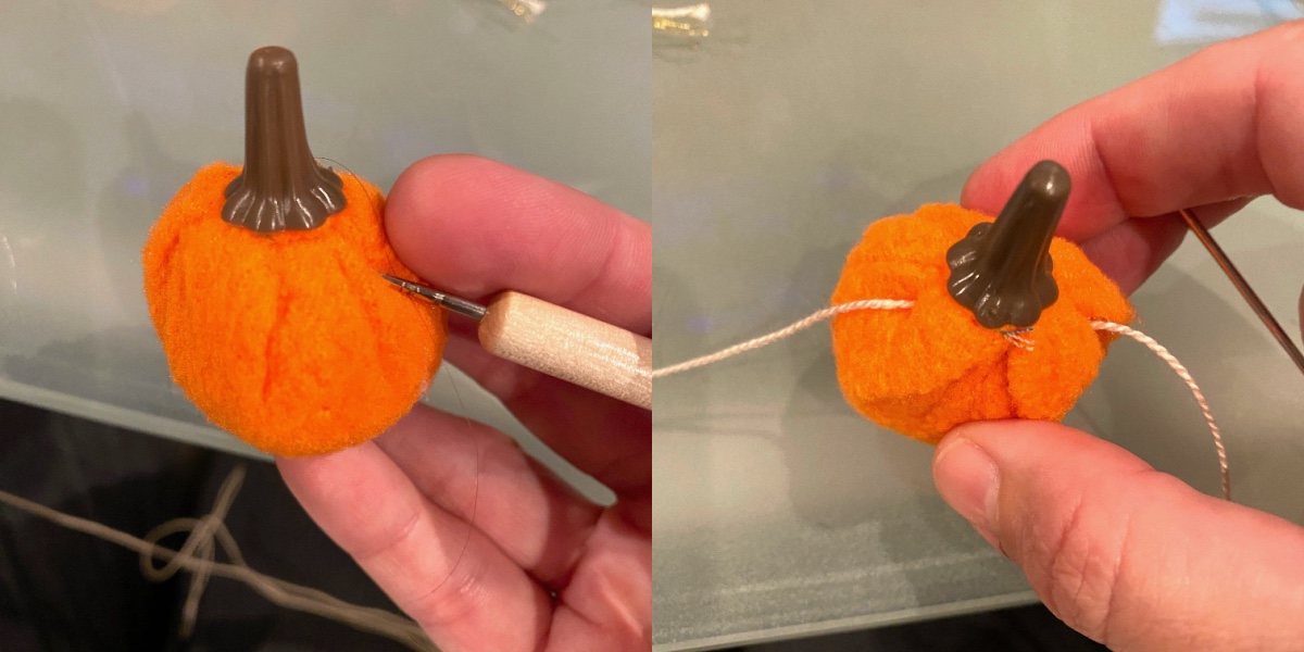 punching a hole into a felt pumpkin and pushing the thread through