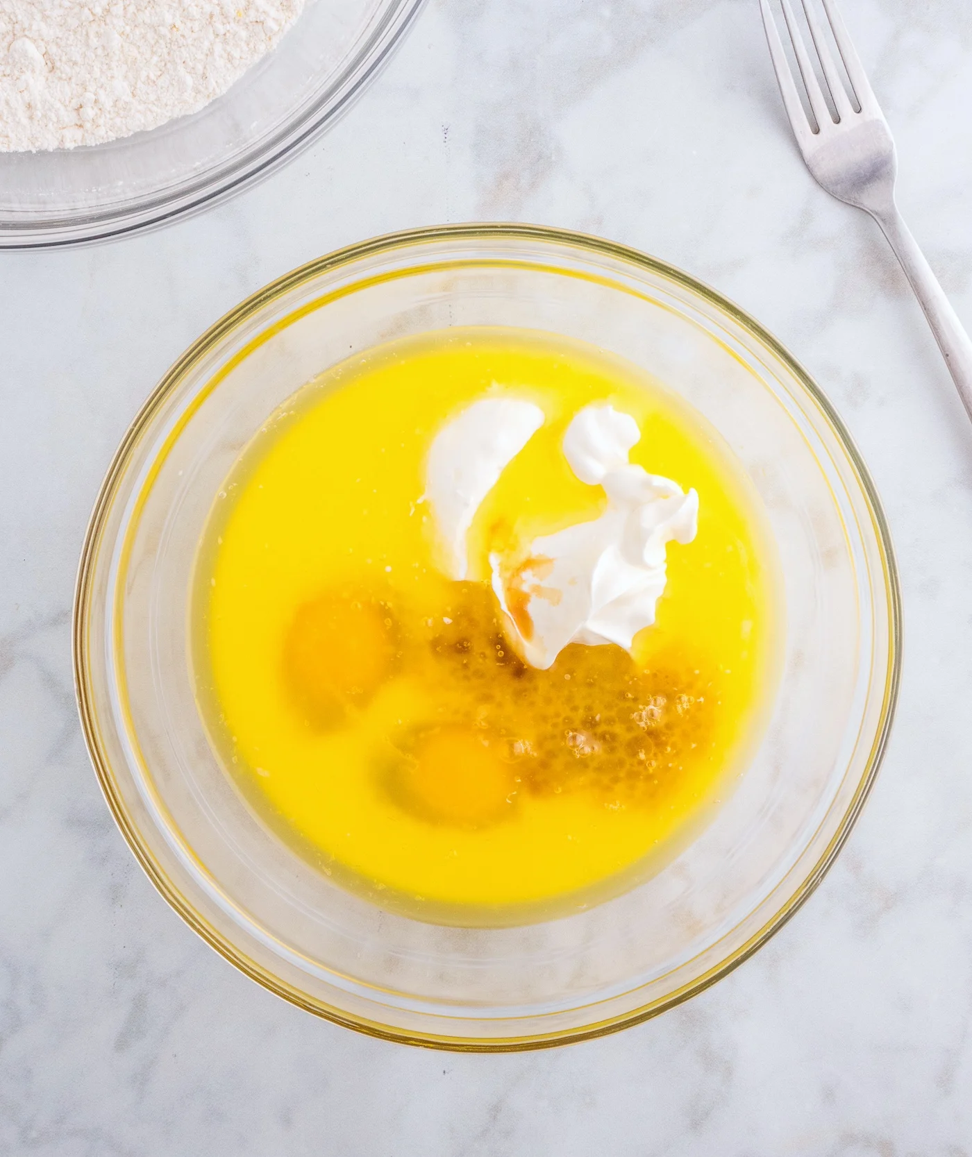whisk together the melted butter, eggs, sour cream, milk, and vanilla extract