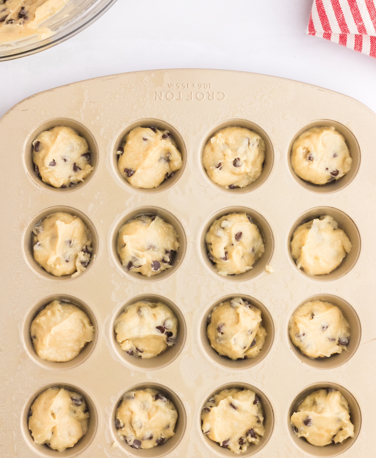 Choc chip muffin batter added to a mini muffin pan