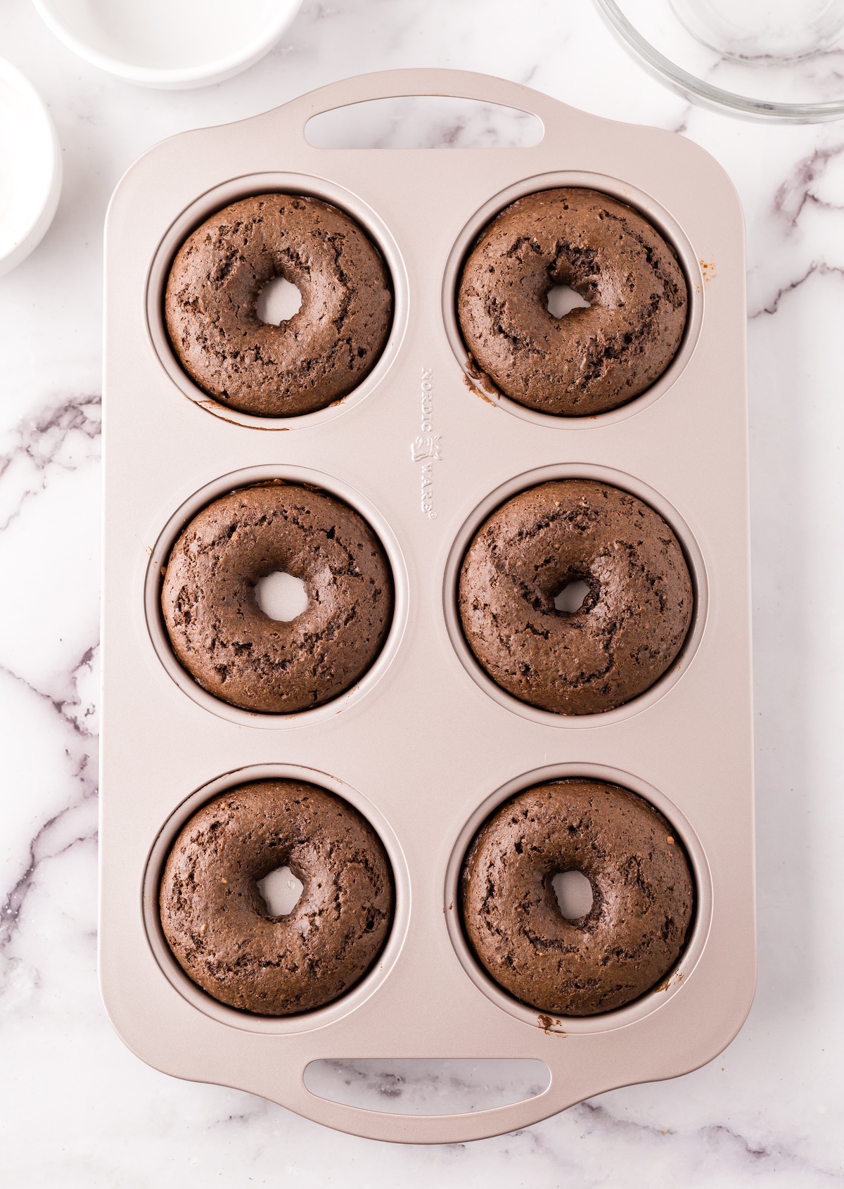 Chocolate donuts baked and cooling in a donut pan