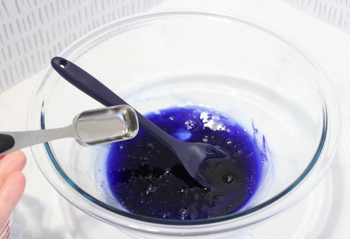 Add borax mixture to the blue and purple slime