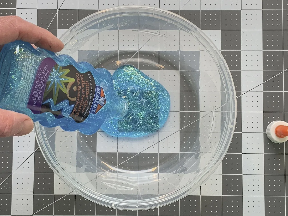Add glitter glue to a bowl