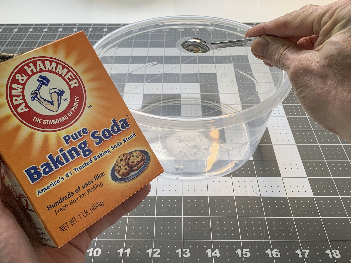 Adding the baking soda to the container