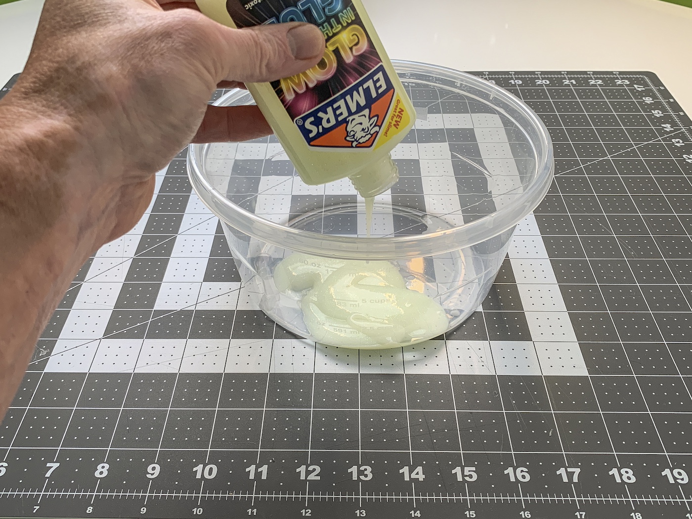Adding the glow in the dark glue to the container
