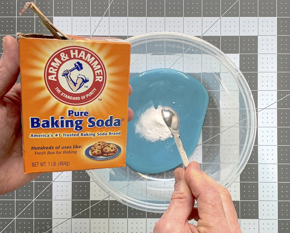 Adding to the baking soda to the blue glue