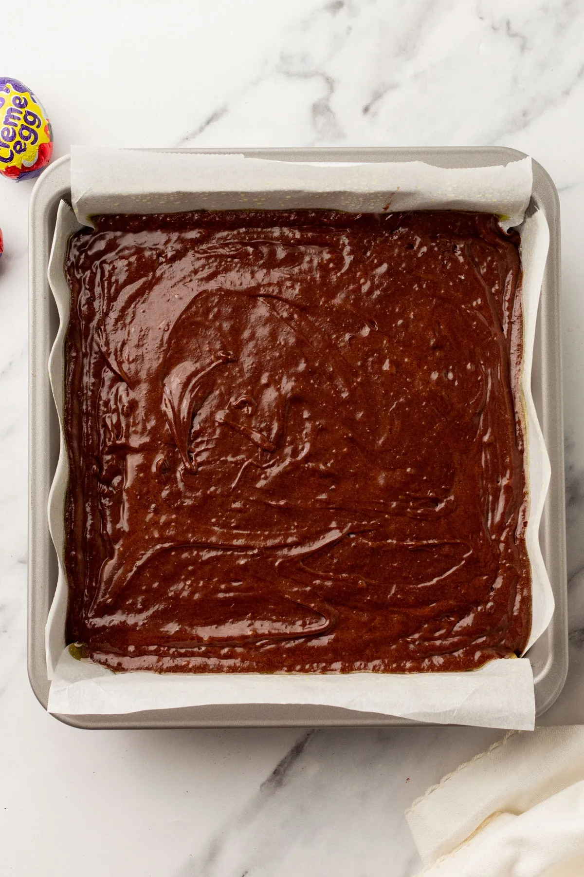 Brownie batter poured into the pan