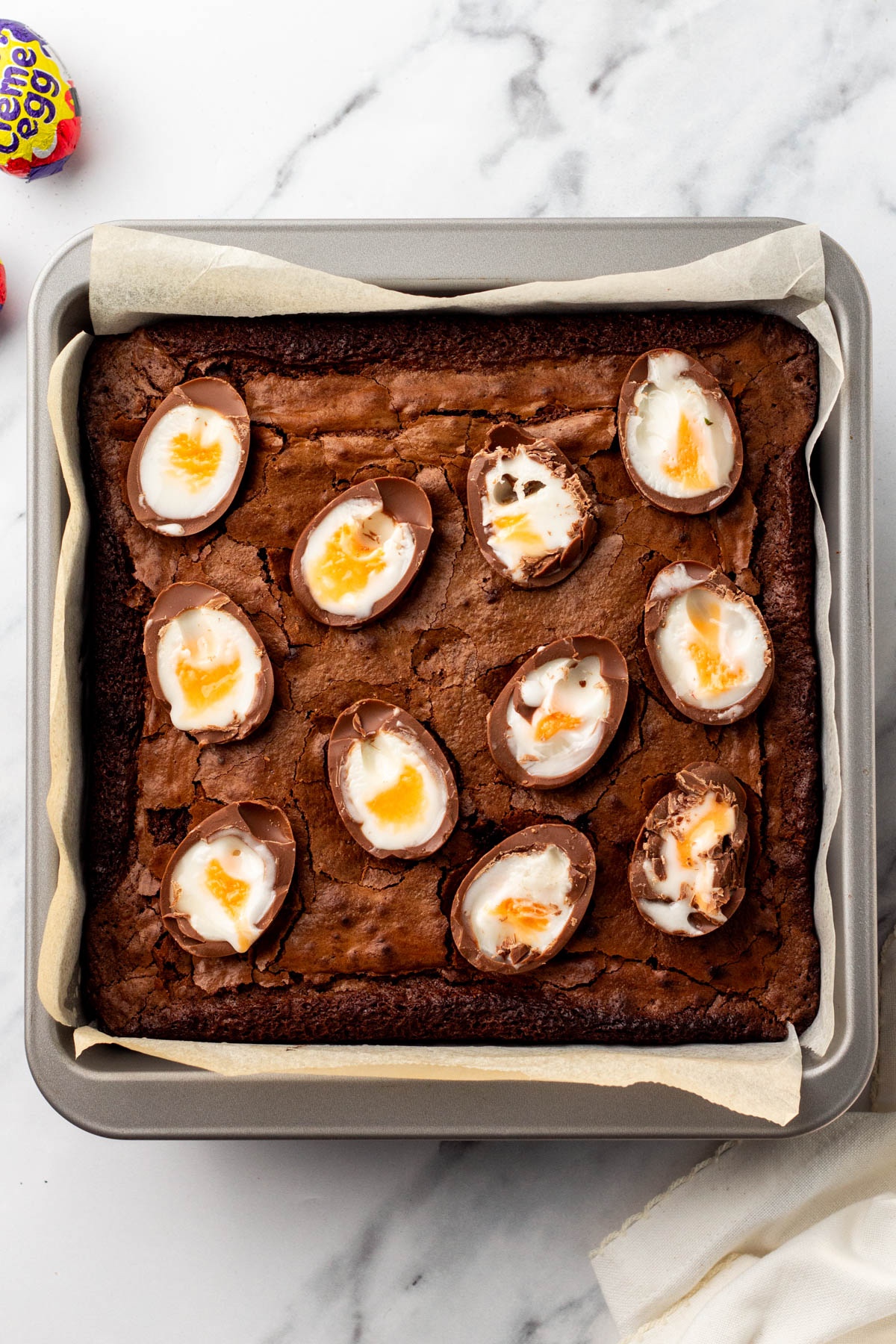 Cadbury eggs pushed down into the brownies