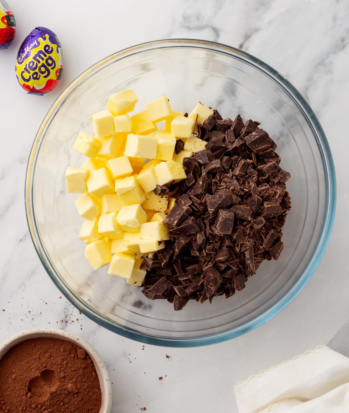 Chopped butter and dark chocolate added to a bowl
