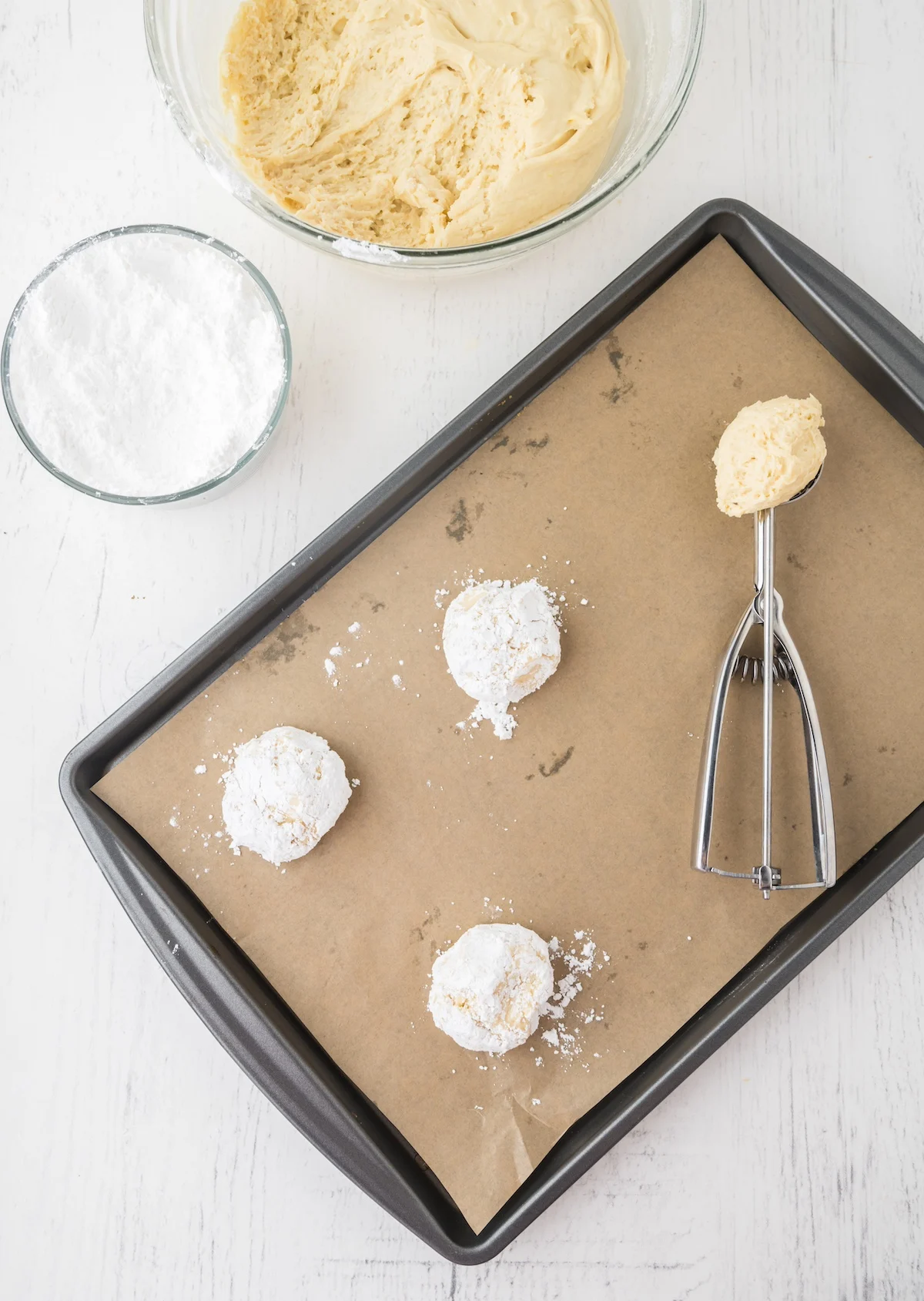 Lemon dough being scooped onto a cookie sheet