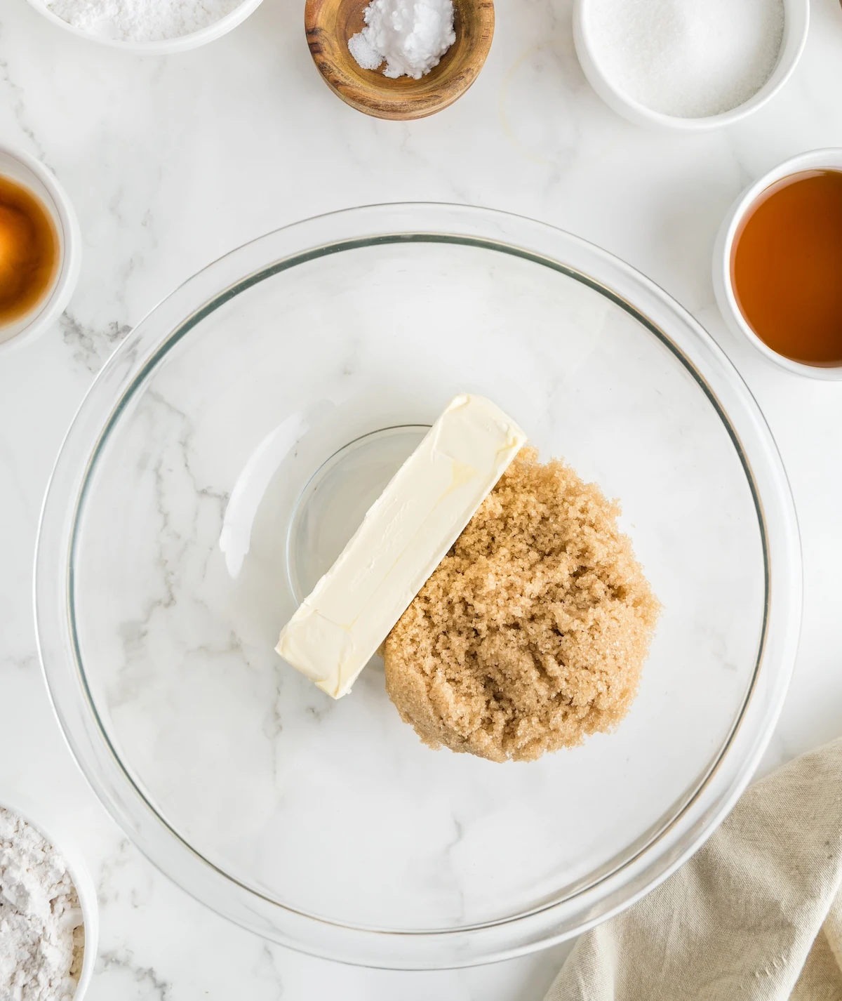 Stick of butter and brown sugar in a clear glass bowl