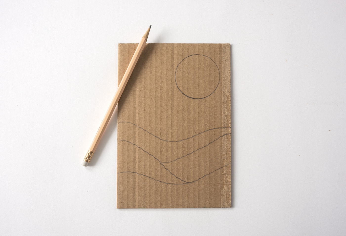 Drawing the design on cardboard with a pencil
