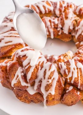 Icing being drizzled over the top of the monkey bread