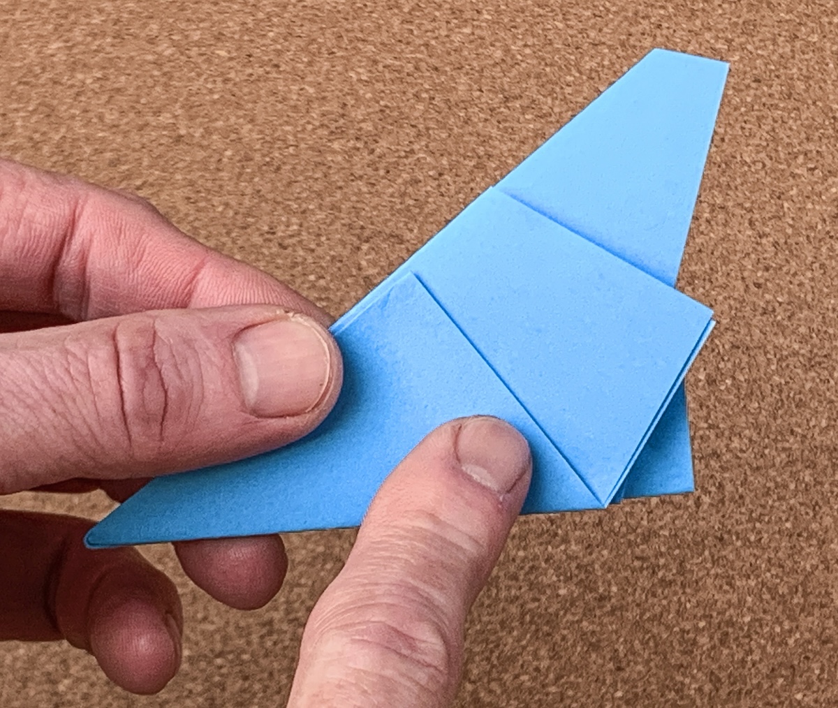 Note the shortest edge of the paper to cut in the next step.
