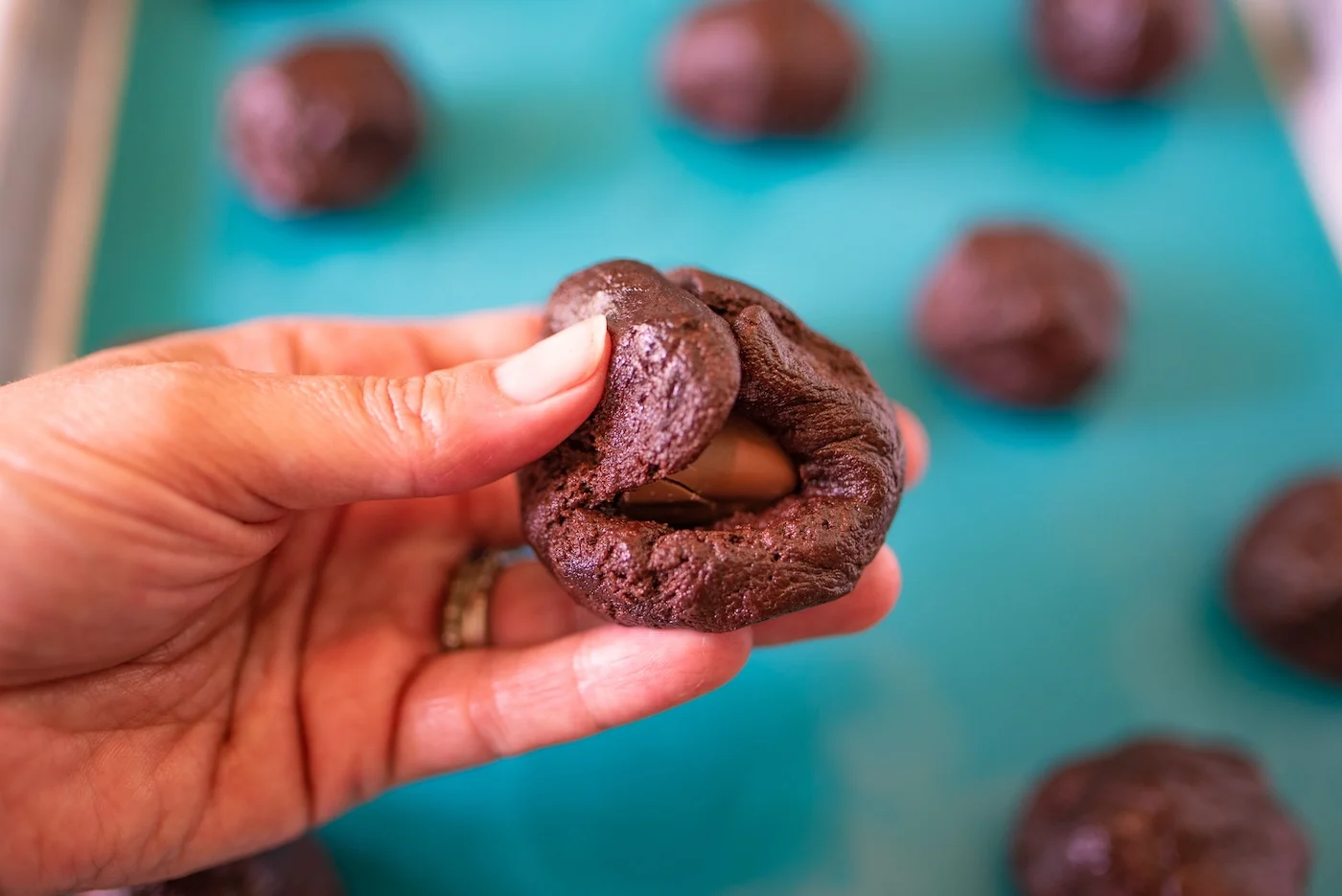 Wrapping the cookie dough around the milky way piece