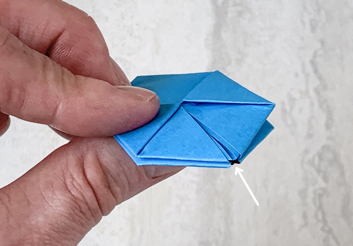 identify the hole on the side of the cube and blow into it