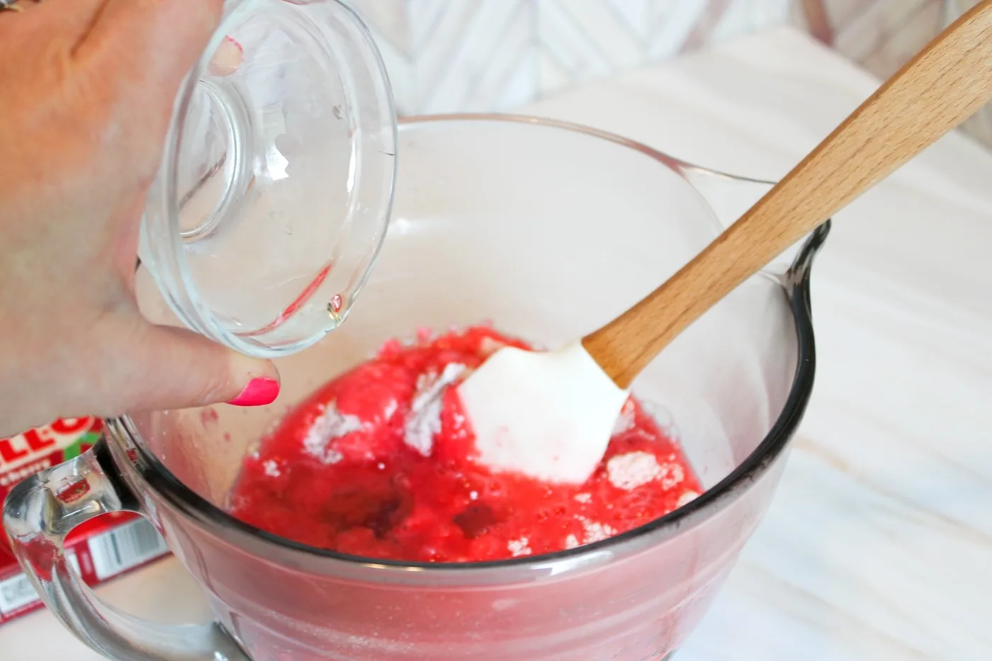 Adding boiling water to the jello and dry ingredients