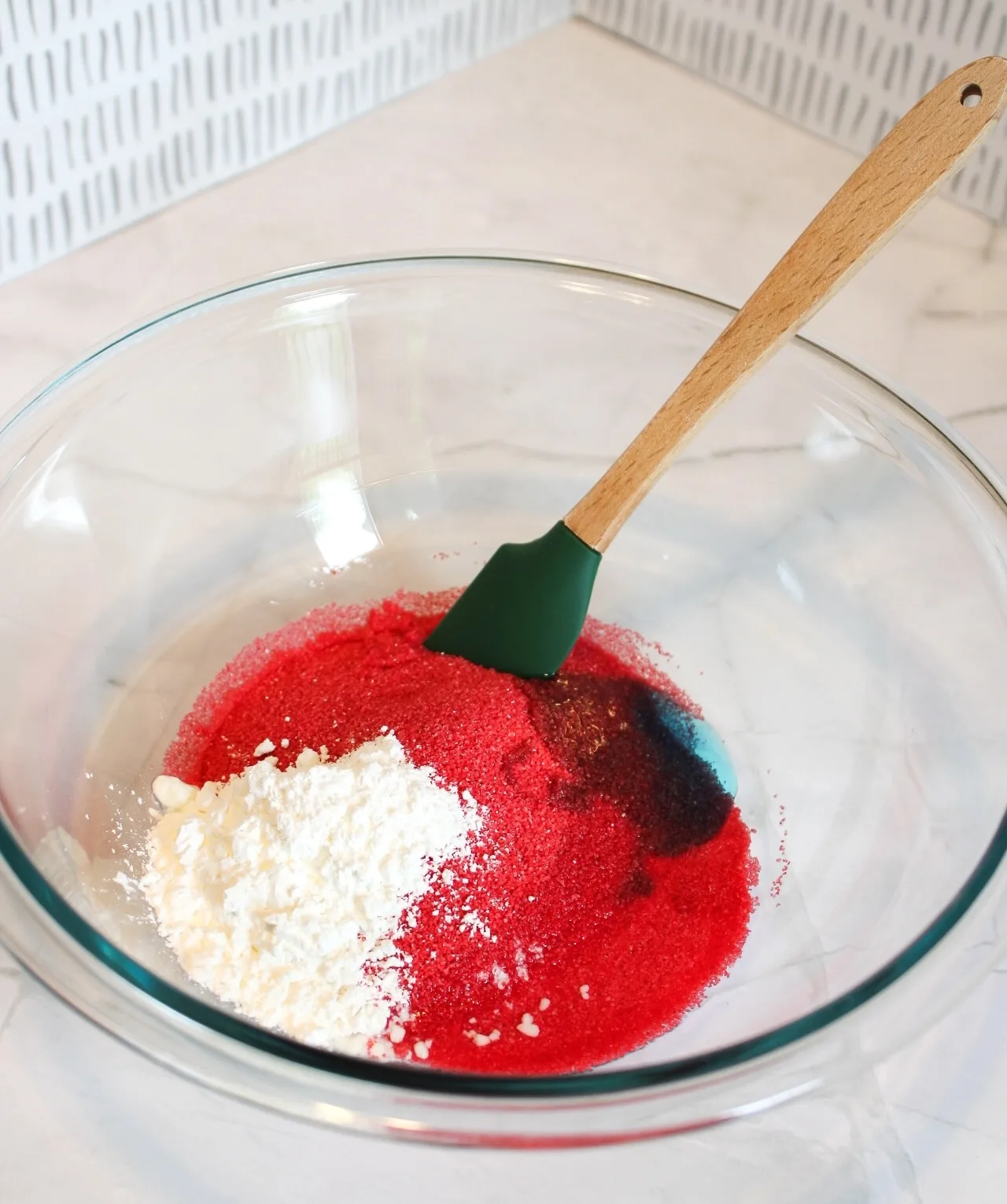 mixing sand, corn starch, dish soap, and water in a bowl