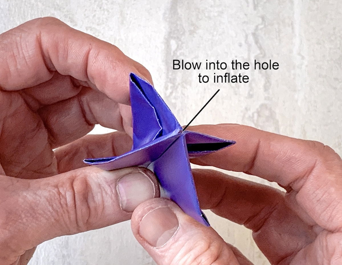 blow into the end of the shape to inflate it