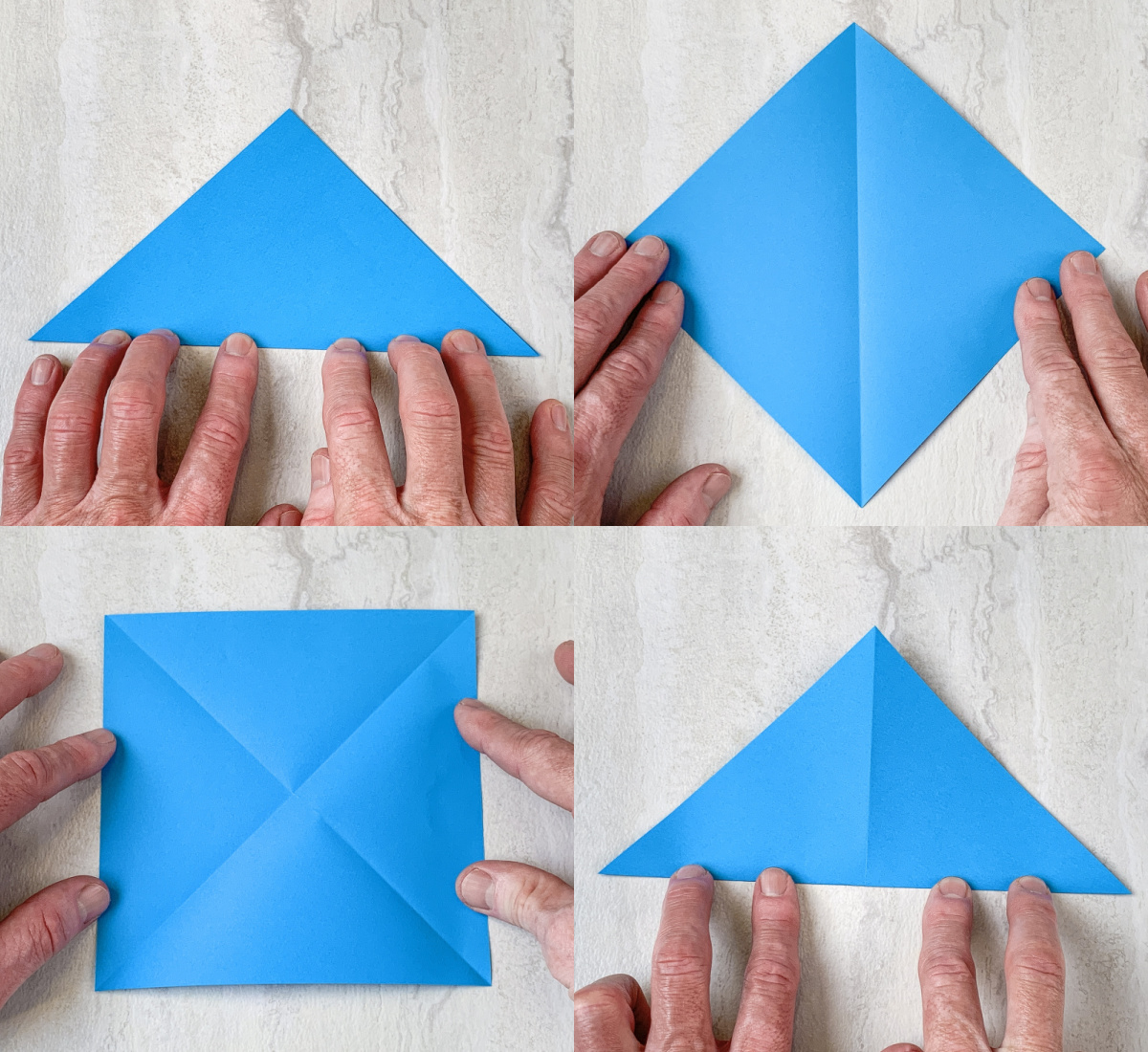 folding blue origami paper into a triangle and opening it up again