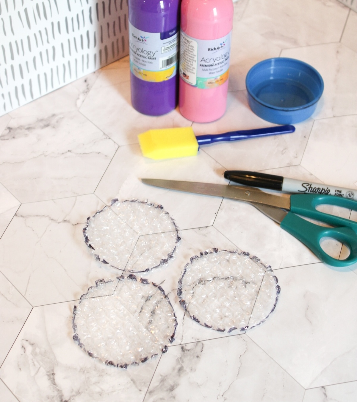 cutting out shapes from bubble wrap using scissors