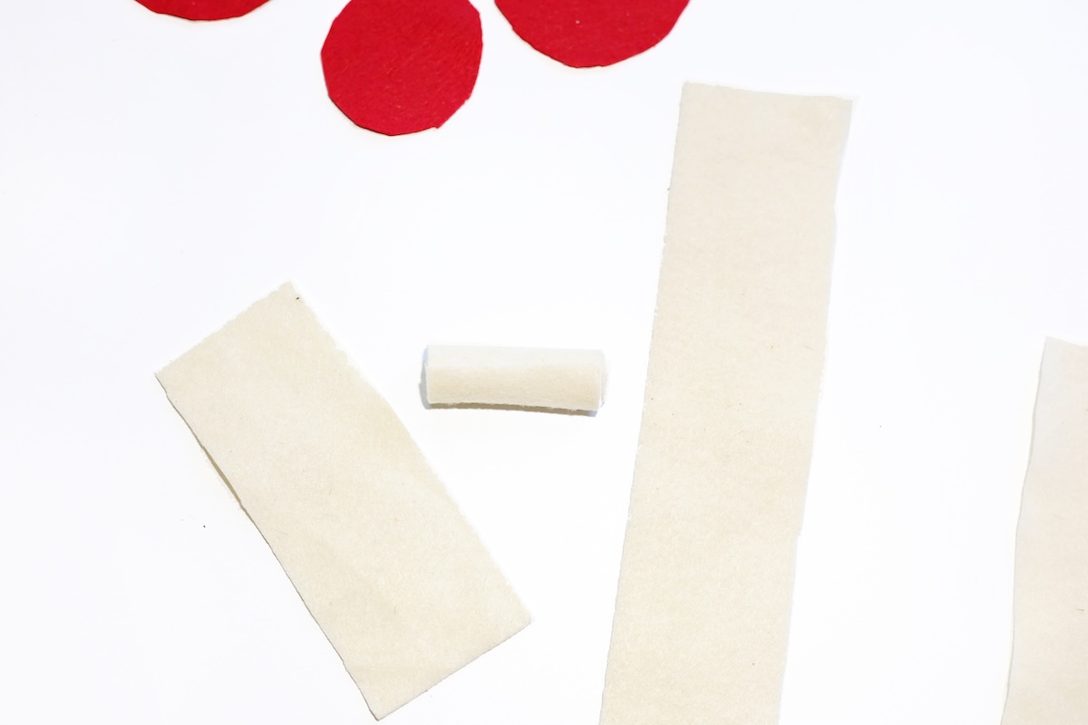 Cutting white felt and rolling into stems