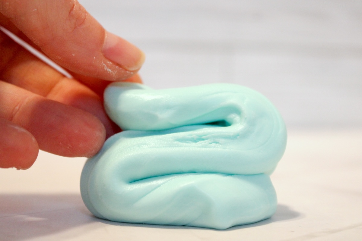 hand playing with homemade silly putty