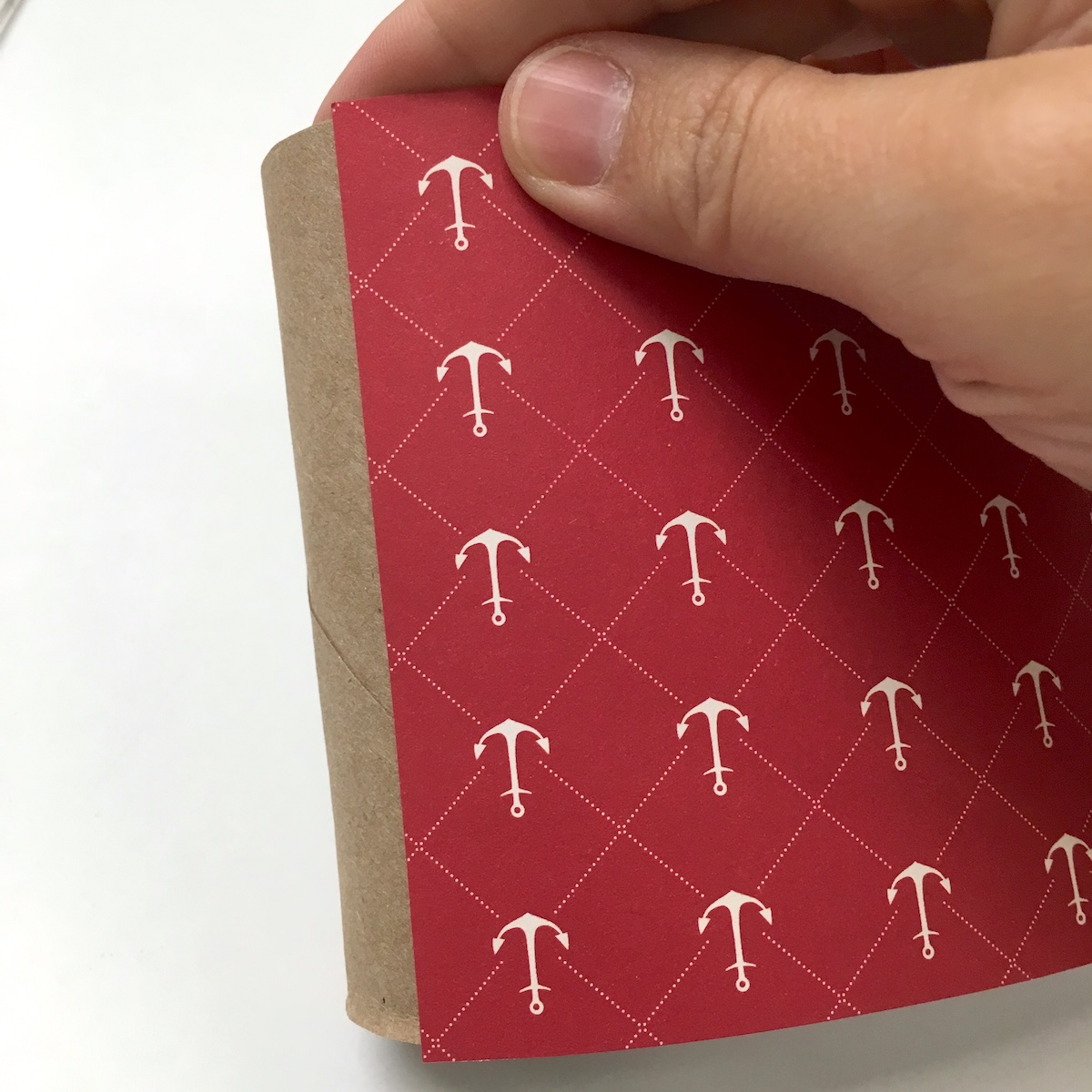 Attaching paper to the toilet paper roll