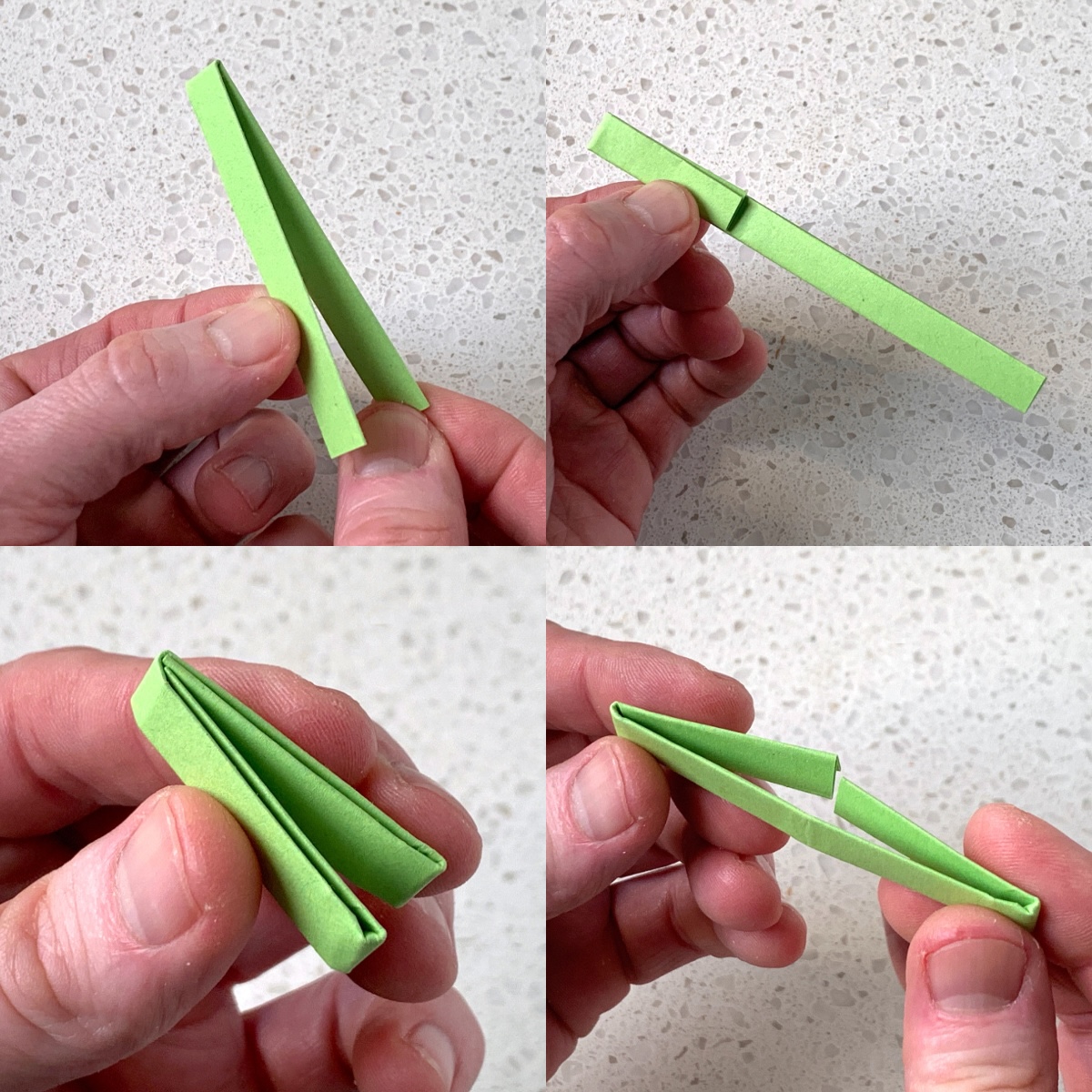 folding a long strip of green origami paper in half twice