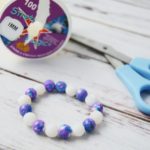 scissors, elastic cord, and a beaded bracelet